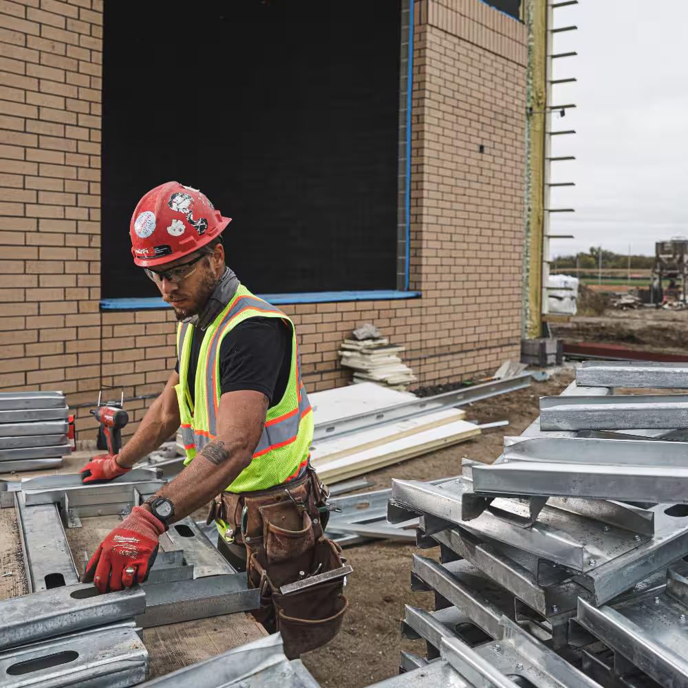 Crew member staging steel framing at a commercial build-out